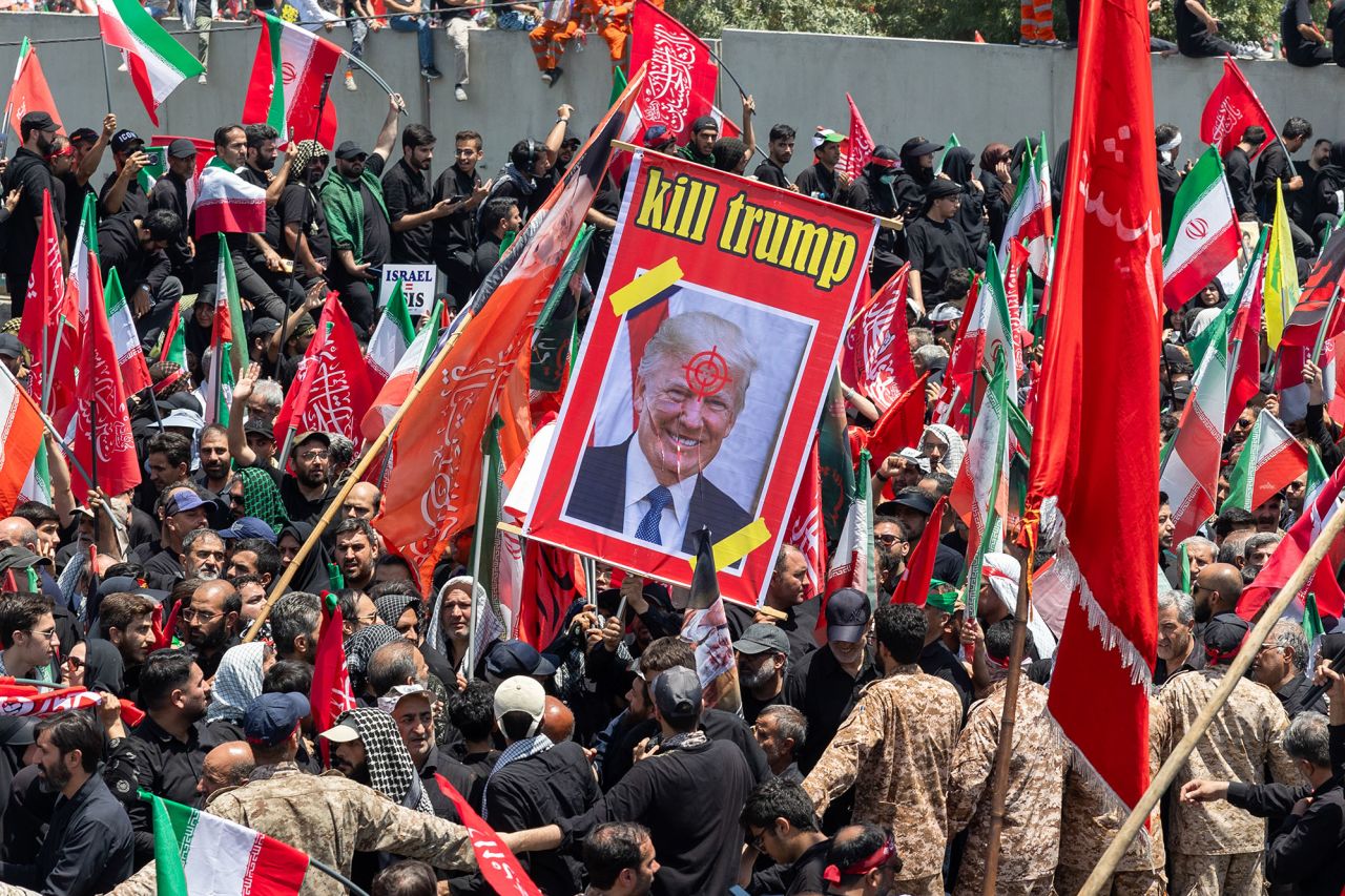 A poster with the slogan 'Kill Trump' is displayed as mourners gather to pay final respects to Iran's slain Supreme Leader Ayatollah Ali Khamenei on Monday.