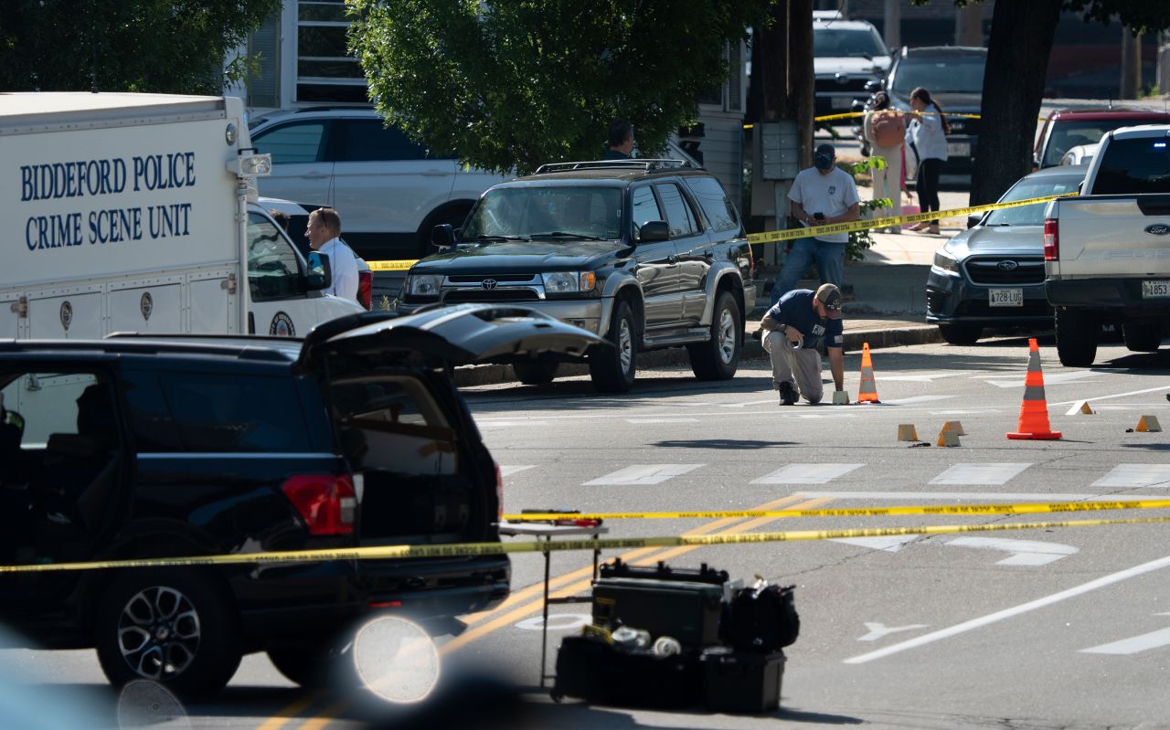 An FBI official places an evidence card on Pool Street in Biddeford where a man was reportedly killed in a shooting involving US Immigration and Customs Enforcement agents on Monday.