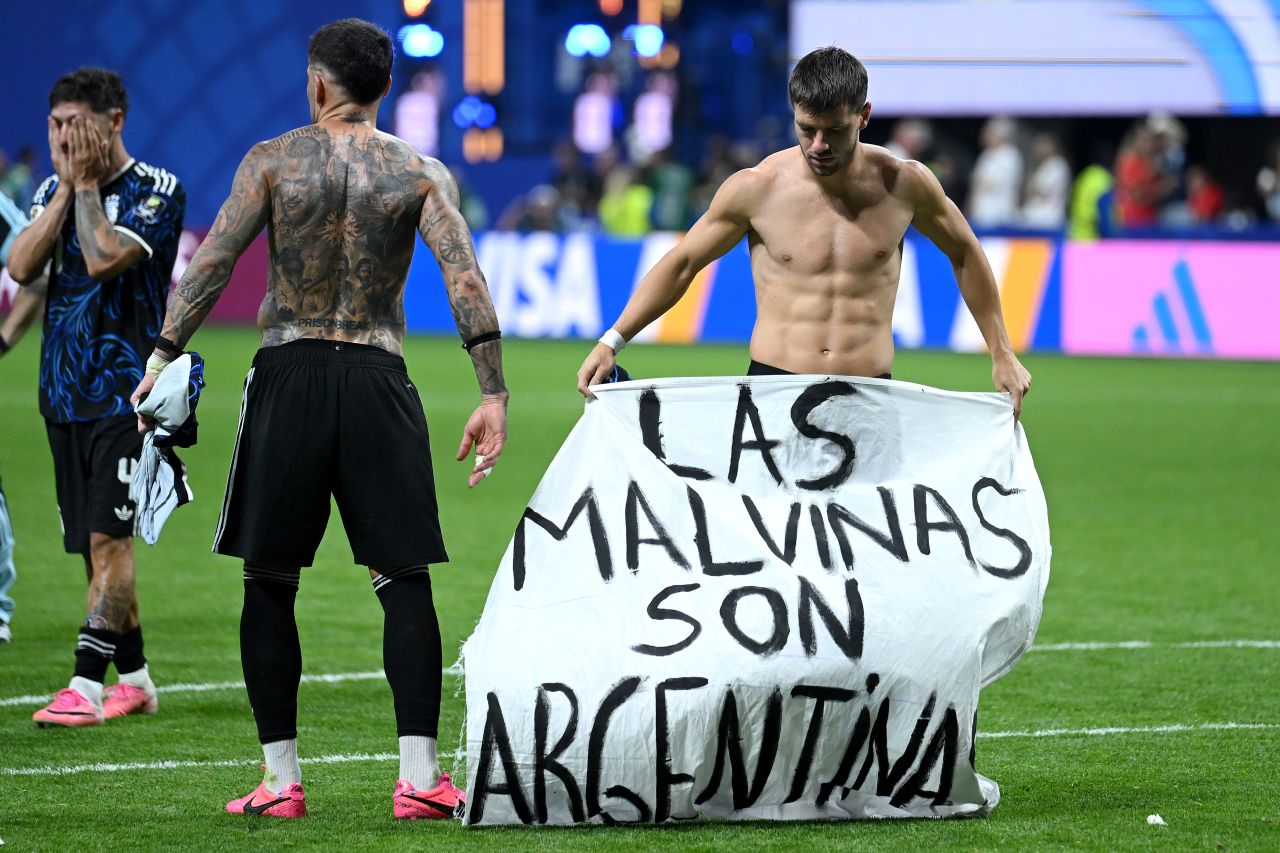 Argentina's Giovani Lo Celso holds a banner after the semifinal win against England.
