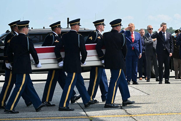 President Trump and Defense Secretary Pete Hegseth salute during a dignified transfer for Sgt. Angel S. Rampersad at Dover Air Force Base in Dover, Delaware, on July 22, 2026.