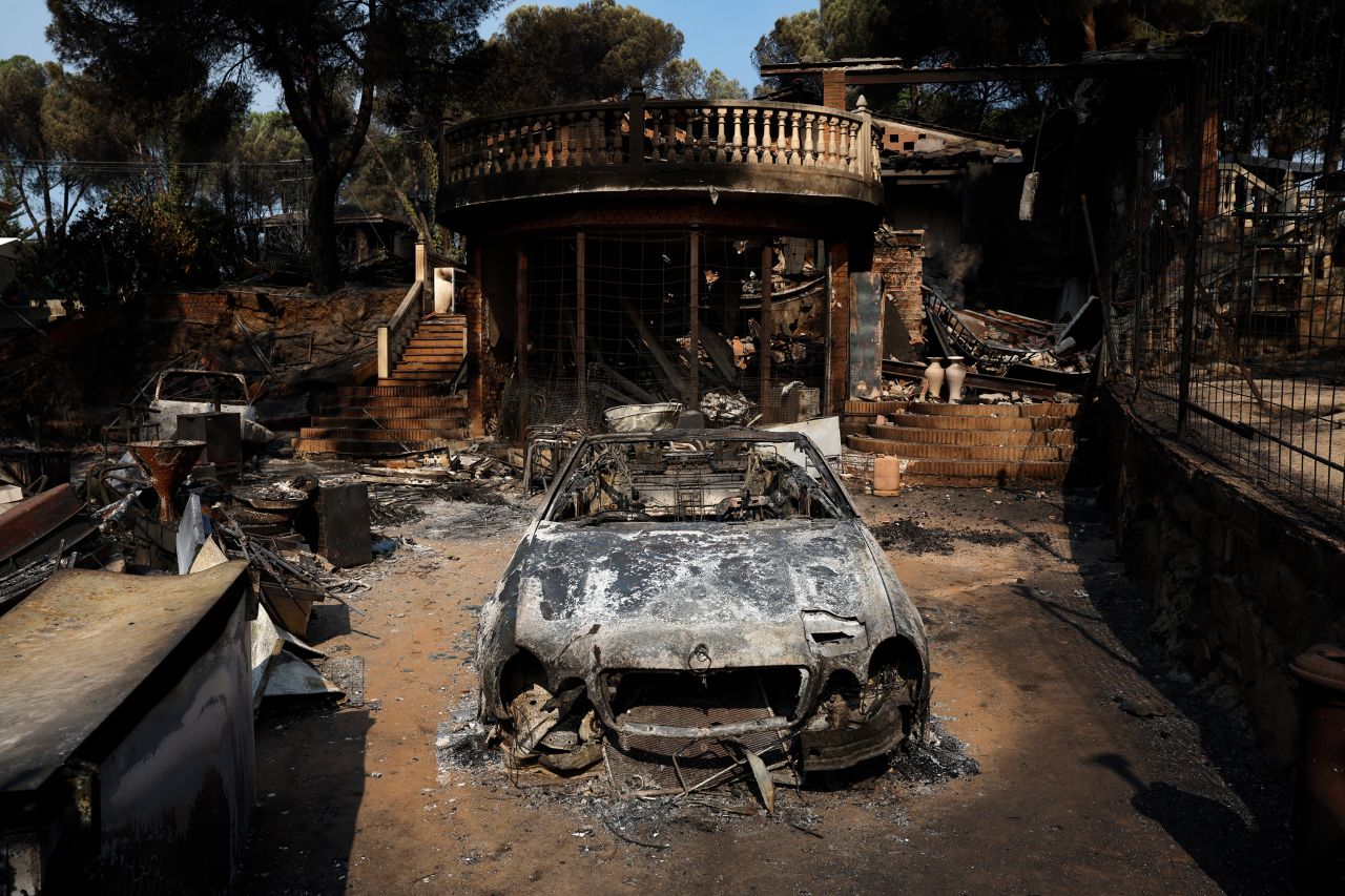 A burned out car and home are seen in Pelayos de la Presa, Spain.