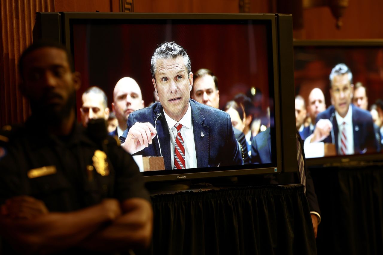 A screen displays Secretary of Defense Pete Hegseth testifying on Tuesday.