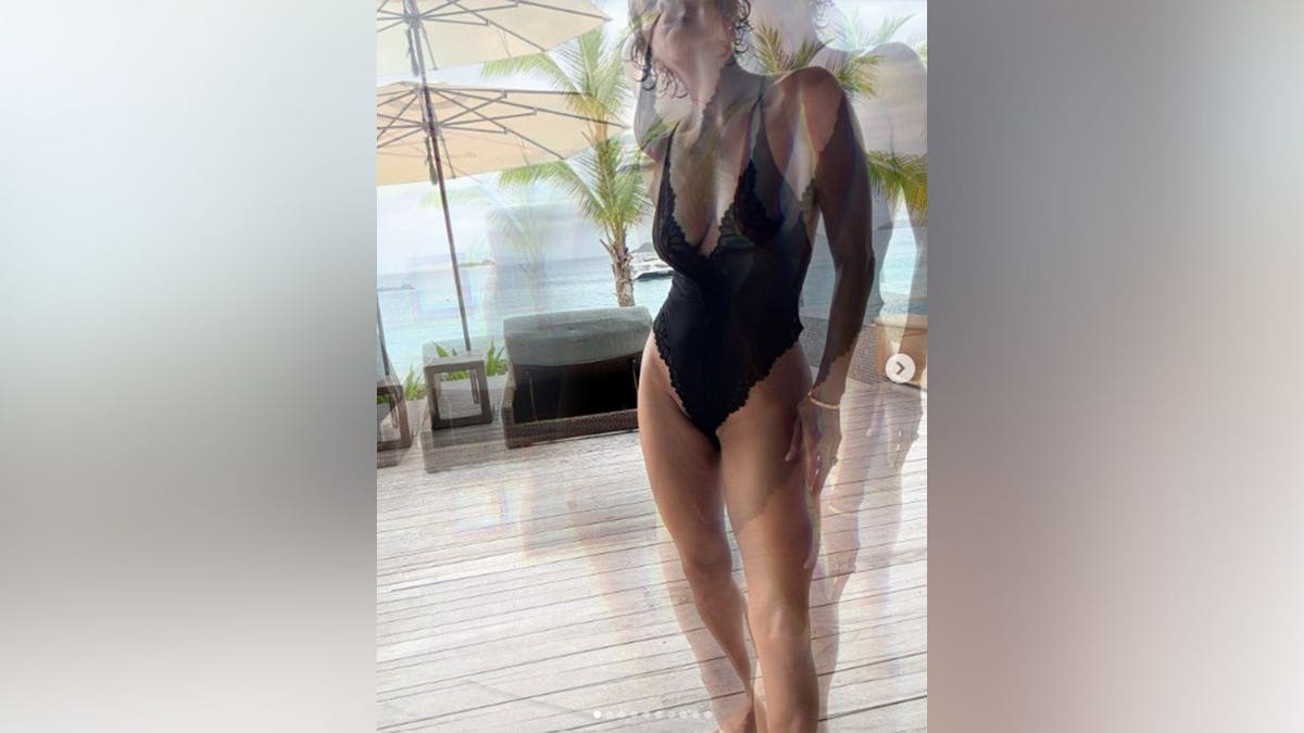 Halle Berry stands in a black one-piece outfit while on vacation with Van Jones.