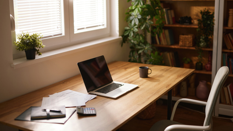 A 16-inch macbook on a wooden home office desk
