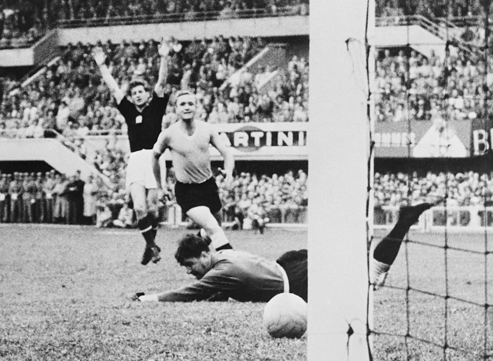 Hungarian forward Sandor Kocsis (L) celebrates as the ball rolls past Uruguayan goalkeeper Gaston Roque Maspoli into the net for a goal as defender Jose Santamaria looks on 30 June 1954 in Lausanne during the World Cup semifinal match between Hungary and Uruguay. Hungary advanced to the final with a 4-2 victory in extra time. (Photo by AFP via Getty Images)