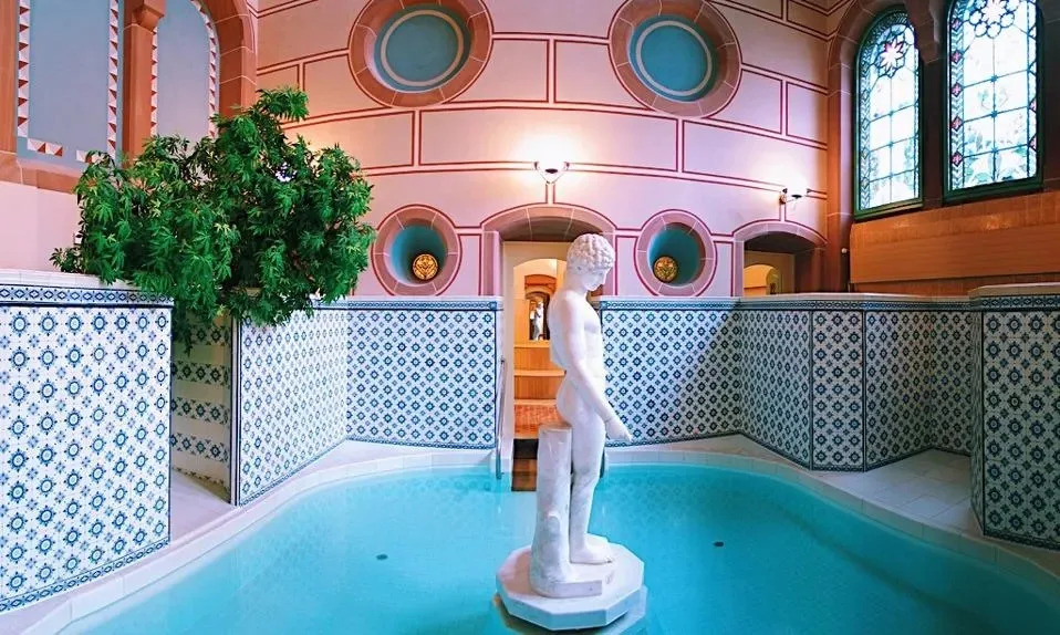 Historic indoor thermal pool at Palais Thermal in Bad Wildbad, Germany, featuring Art Nouveau architecture and mineral baths.
