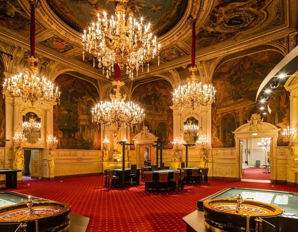 Ornate interior of Casino Baden-Baden, Germany, featuring chandeliers and historic architecture.