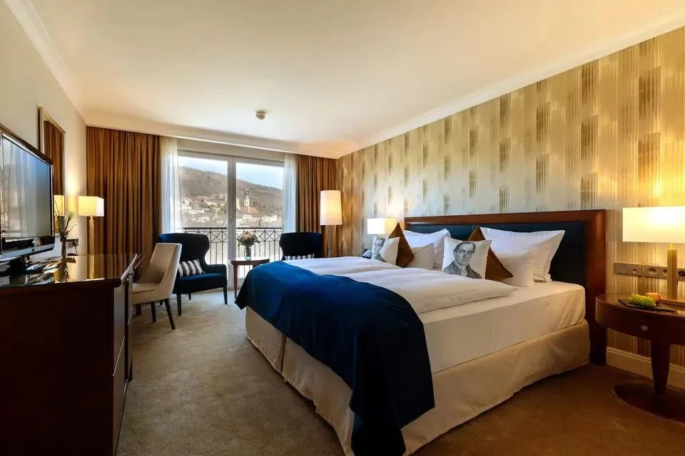 Spacious guest room at Dorint Maison Messmer hotel in Baden-Baden, Germany, a luxury base for exploring the Black Forest's thermal spas.