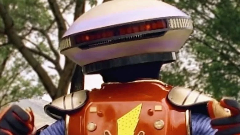 Alpha 5 stood in a forest in Mighty Morphin Power Rangers
