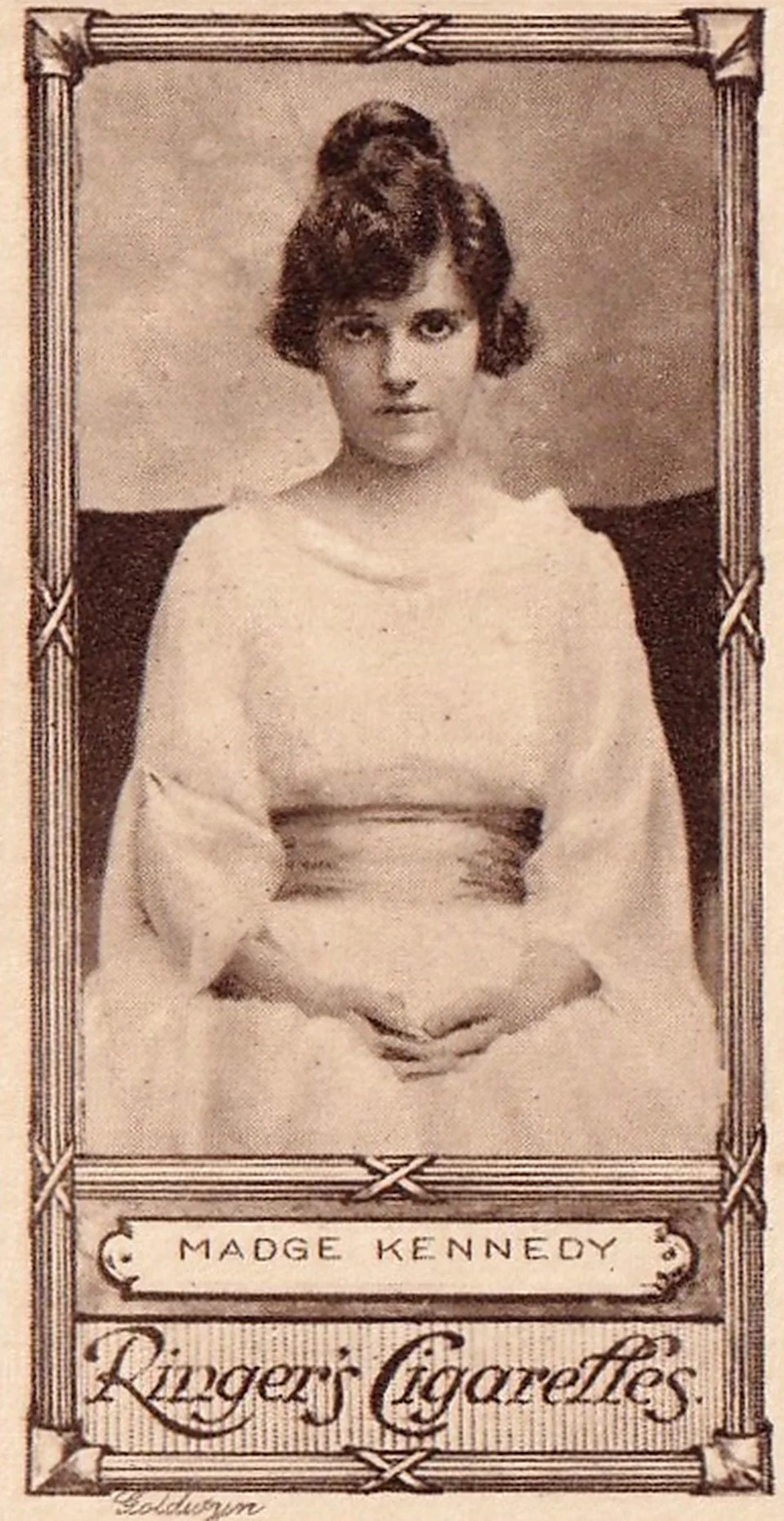 Vintage portrait of Madge Kennedy in an elegant dress, sitting with hands clasped, featured on a historical cigarette card