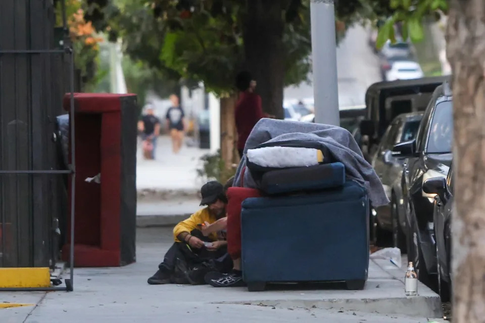 A man experiencing homelessness is seen on the Hollywood Walk of Fame. Rafael Fontoura for CA Post