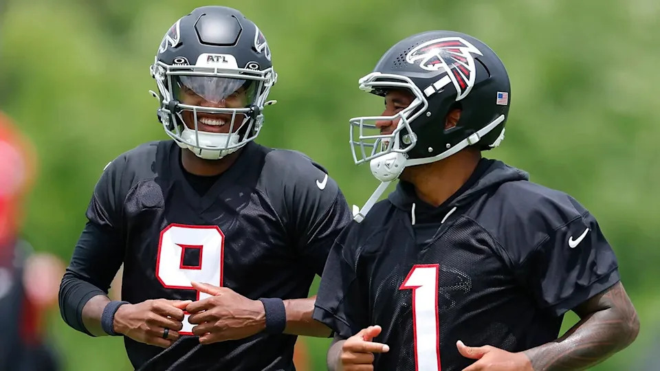 Michael Penix Jr. and Tua Tagovailoa laugh during OTAs at IBM Performance Field.