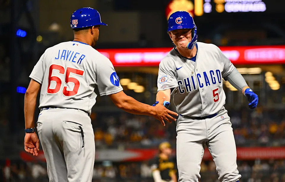 PITTSBURGH, PENNSYLVANIA - JULY 25: James Triantos #5 of the Chicago Cubs celebrates at first base with first base coach Jose Javier #65 after hitting a single for his first MLB hit during the eighth inning of his Major League debut against the Pittsburgh Pirates at PNC Park on July 25, 2026 in Pittsburgh, Pennsylvania. (Photo by Justin Berl/Getty Images)
