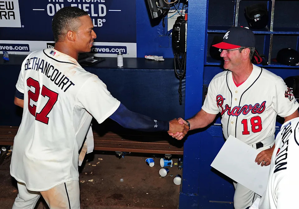 ATLANTA, GA - JUNE 6: Christian Bethancourt #27 of the Atlanta Braves is congratulated by Bench Coach Carlos Tosca #18 after hitting a walk-off ninth inning solo home run against the Pittsburgh Pirates at Turner Field on June 6, 2015 in Atlanta, Georgia. (Photo by Scott Cunningham/Getty Images)