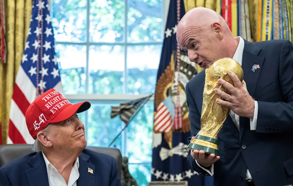 FIFA President Gianni Infantino hands the World Cup trophy to President Donald Trump in the Oval Office of the White House in Washington, DC, on August 22, 2025. / Andrew Caballero-Reynolds/AFP via Getty Images