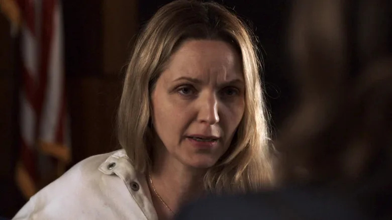 Delia Hackman in a white jacket sitting in a room facing Olivia Benson in Law & Order: SVU