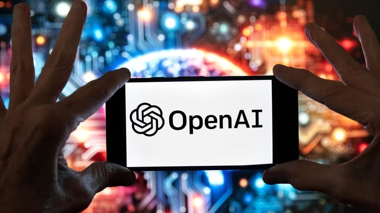 The OpenAI logo is displayed on a cell phone in...