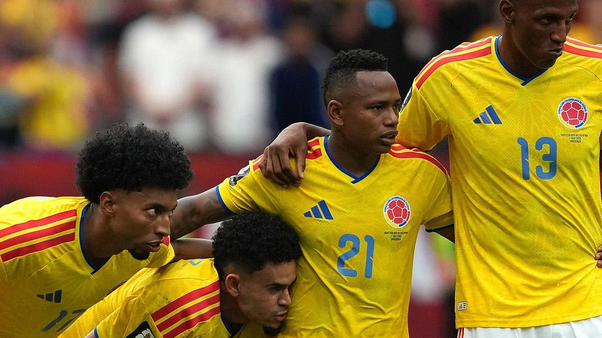 Johan Mojica, Luis Diaz, Jaminton Campaz and Yerry Mina stand during a penalty shootout.