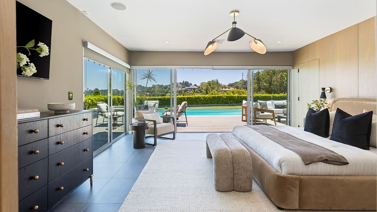 A large bedroom with access to the backyard.