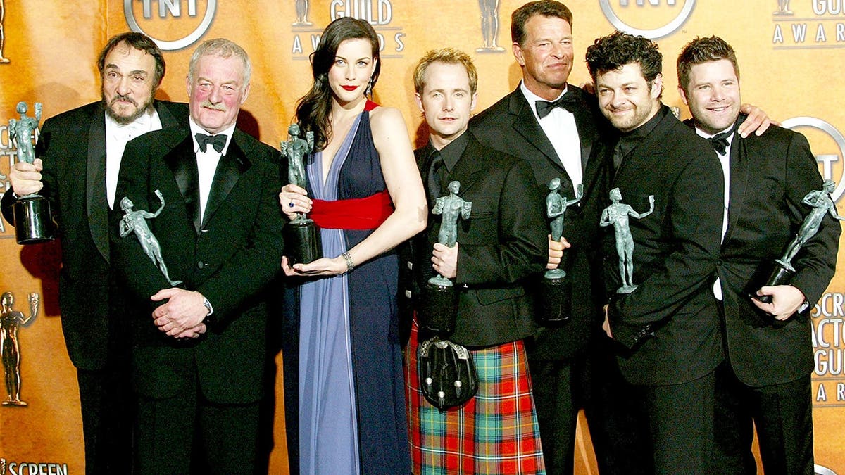 John Rhys-Davies, Bernard Hill, Liv Tyler, Billy Boyd, John Noble, Andy Serkis and Sean Astin posed backstage with their awards after "The Lord of the Rings: The Return of the King" won Outstanding Performance by a Cast in a Motion Picture at the 10th Annual Screen Actors Guild Awards on Feb. 22, 2004, in Los Angeles.