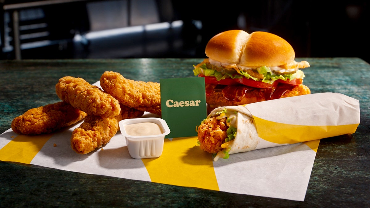 A McDonald's burger, tenders, Caesar Snack Wrap and Caesar Sauce are shown.