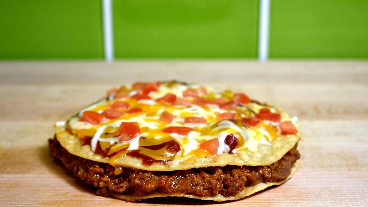 A Mexican pizza from Taco Bell sits on a table.