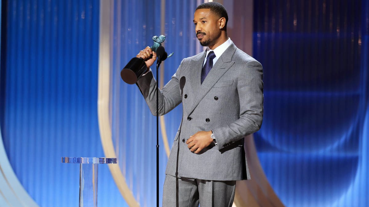 Michael B. Jordan accepts an award onstage at the Shrine Auditorium and Expo Hall.