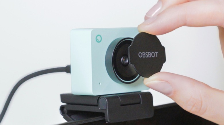 Person placing lens cover on a blue Osbot Meet 2