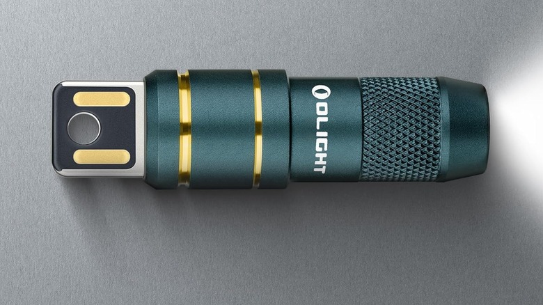 Olight on its side with the flashlight on
