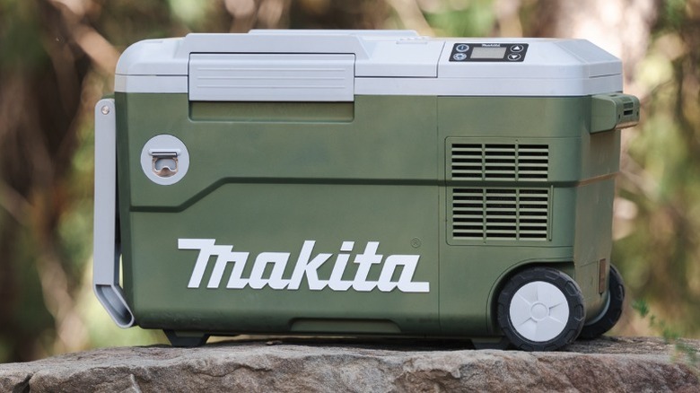 Makita Outdoor Adventure 18V Cooler/Warmer on a rock in the woods