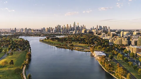 Getty Images Aerial view of Melbourne's skyline with the Yarra River in the foreground and blue sky overhead (Credit: Getty Images)
