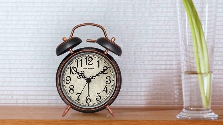 The Peakeep Twin Bell alarm clock on a wooden desk.