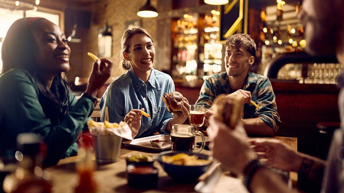 A group of friends eats at a restaurant.