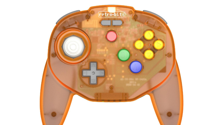 An orange, see-through Retro-Bit V2 Wireless Tribute 64 on a white background