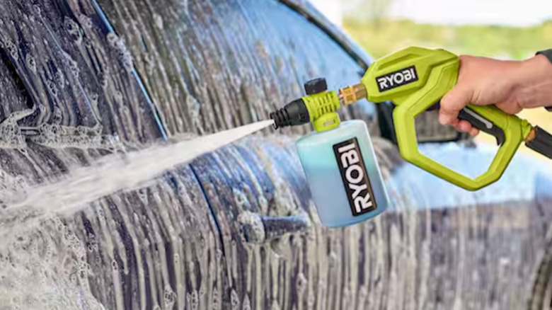 Person using the Ryobi High Flow Pressure Washer on their vehicle