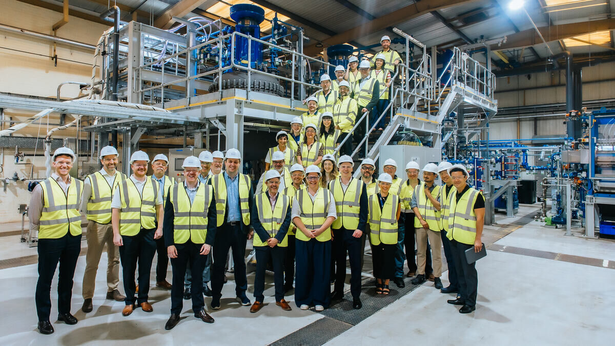 A%20large%20group%20of%20people%20on%20the%20stairs%20of%20a%20recycling%20plant%2E