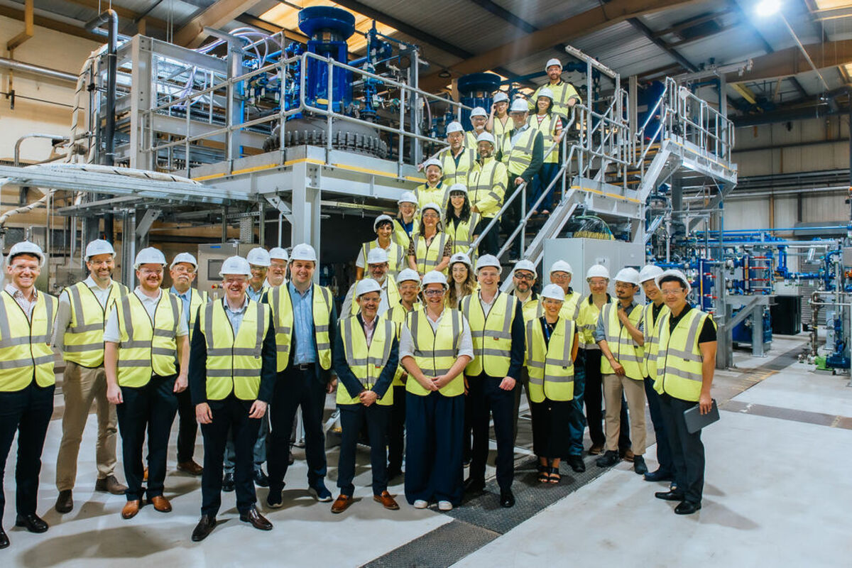 A%20large%20group%20of%20people%20on%20the%20stairs%20of%20a%20recycling%20plant%2E