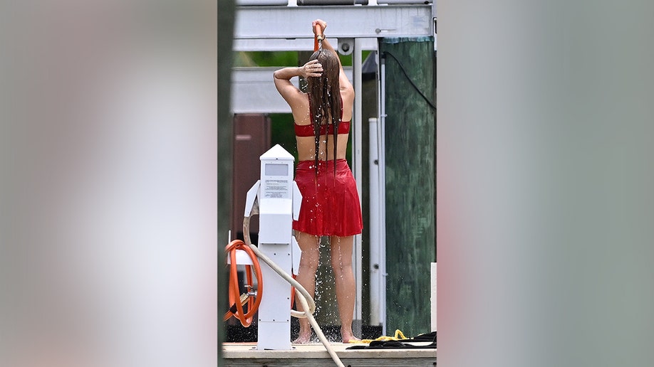 Shakira cleaning off with a hose in Florida in July 2026.