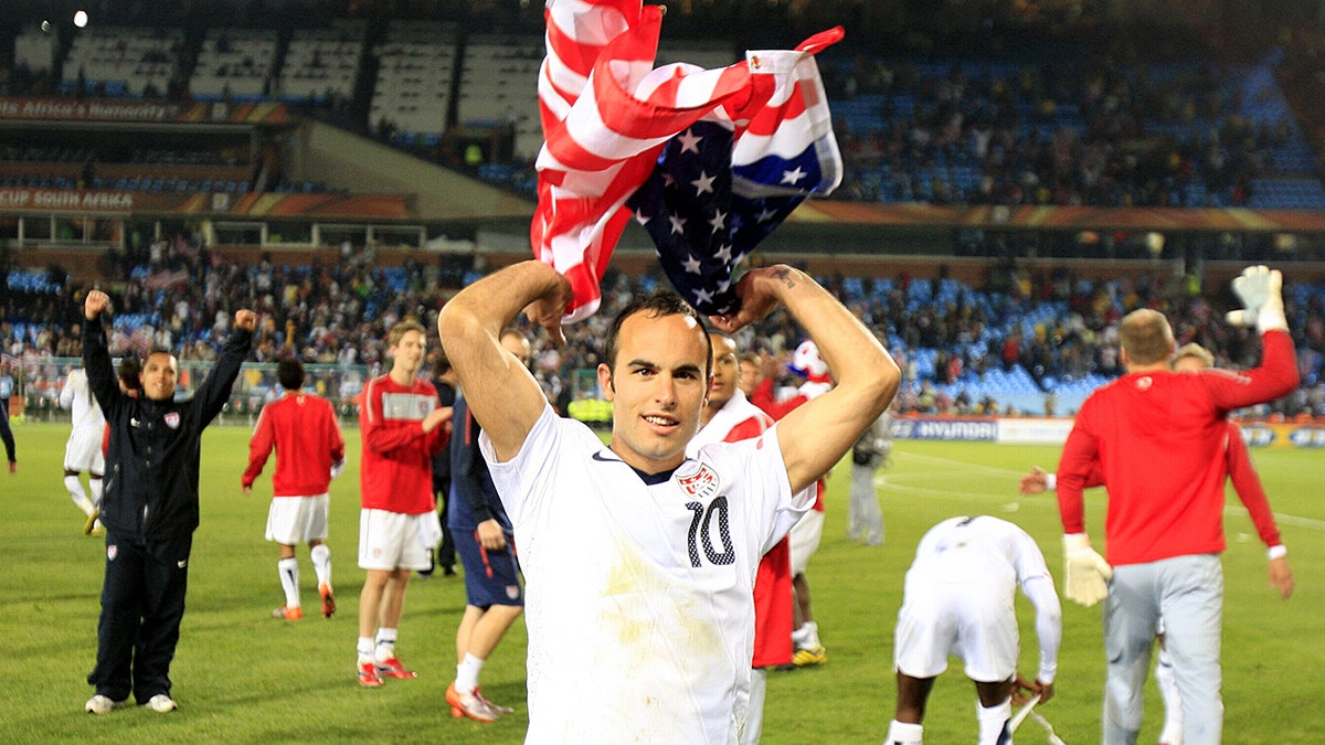Landon Donovan holds the American flag