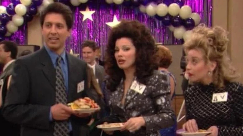 Ray Barone (Ray Romano) stands next to Fran Fine (Fran Drescher) at a high school reunion in The Nanny
