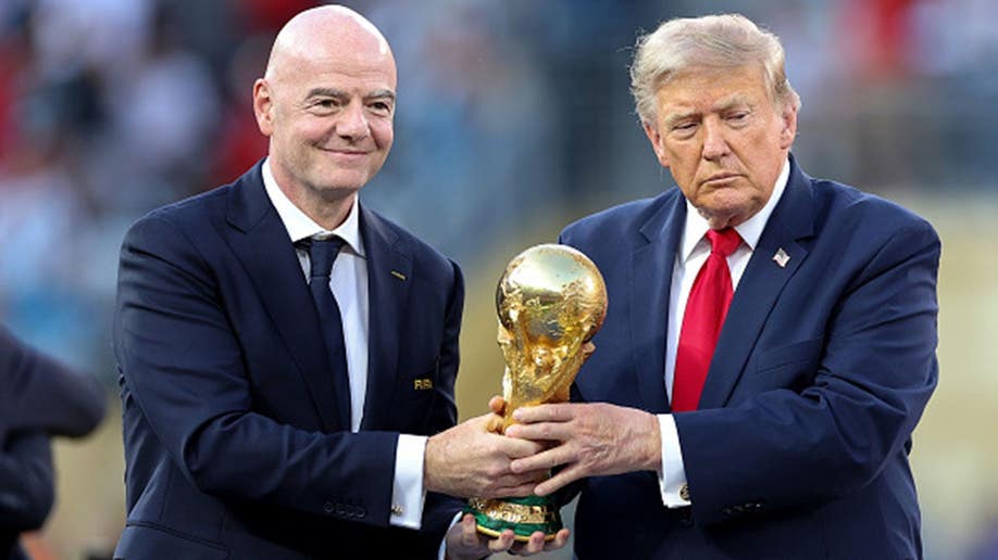 Donald Trump and Gianni Infantino hold the FIFA World Cup trophy.