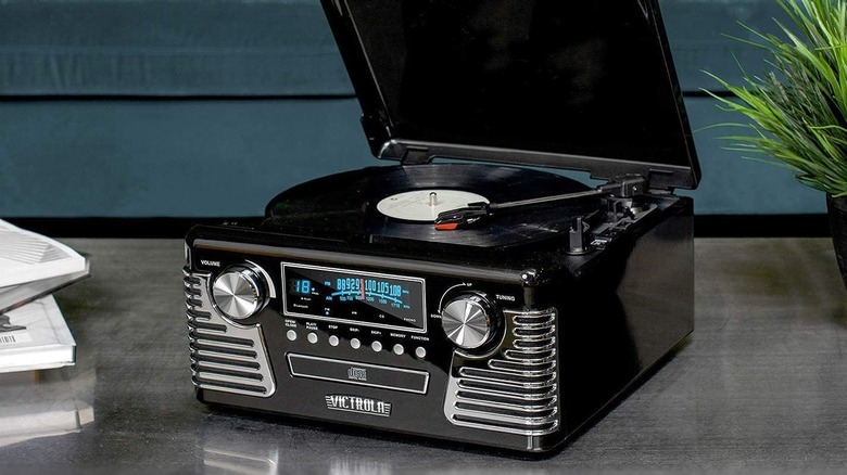 The Victrola Haley record player on a marble surface, playing a vinyl record.