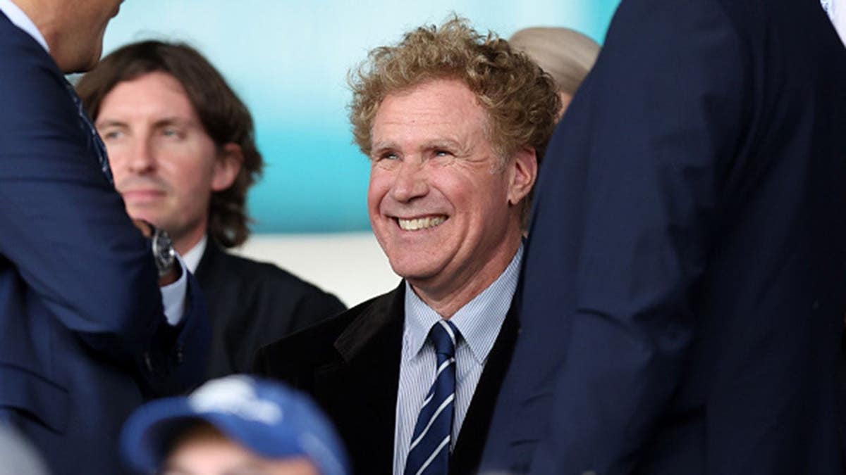 Will Ferrell sits in attendance at Elland Road during a soccer match.