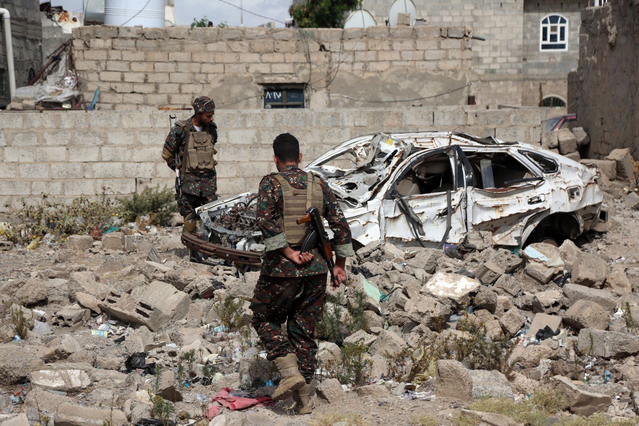 Members of Houthi security forces inspect a destroyed car, which was hit during airstrikes in Sana'a, Yemen, on March 26. Mohammed Hamoud/Getty Images