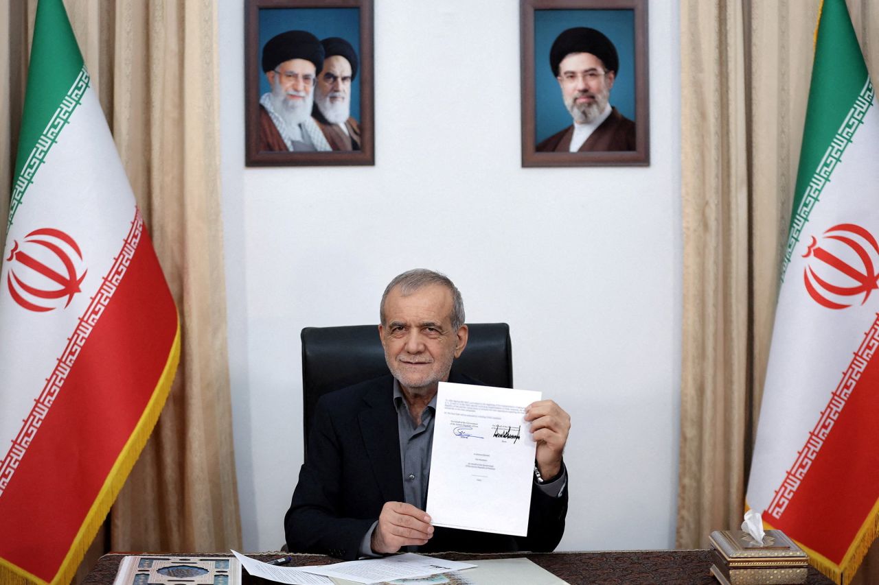 Iranian President Masoud Pezeshkian shows the document of U.S. Memorandum of Understanding in Tehran, Iran, on June 18.