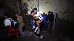 Migrants pass through a broken fence as they leave Spain's North African enclave of Ceuta towards the Moroccan town of Fnideq following an attempted crossing at the Bab Sebta border crossing, on August 1, 2026. More than 48,000 migrants have returned to Morocco from Spain's Ceuta after tens of thousands crossed the frontier into its north African enclave in recent days, Spain's interior ministry said on July 31. Hundreds of people converged on Morocco's northern town of Fnideq on July 30 evening, following rumours that the border with Spain's Ceuta had opened, according to an AFP journalist.