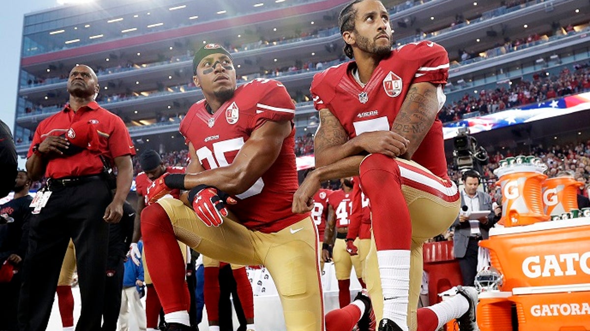FILE - In this Monday, Sept. 12, 2016, file photo, San Francisco 49ers safety Eric Reid (35) and quarterback Colin Kaepernick (7) kneel during the national anthem before an NFL football game against the Los Angeles Rams in Santa Clara, Calif. NFL owners have approved a new policy aimed at addressing the firestorm over national anthem protests, permitting players to stay in the locker room during the "The Star-Spangled Banner" but requiring them to stand if they come to the field. The decision was announced Wednesday, May 23, 2018, by NFL Commissioner Roger Goodell during the league's spring meeting in Atlanta. (AP Photo/Marcio Jose Sanchez, File)