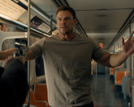 Alan Ritchson as Jack Reacher on a subway train.