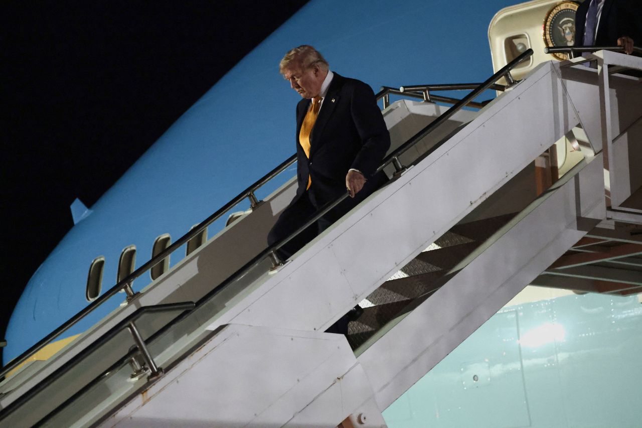 US President Donald Trump walks down the stairs during a stop to switch to the Qatari-gifted Air Force One after arriving on one of the older planes operating as Air Force One, to return to Washington, DC, on July 8, 2026.