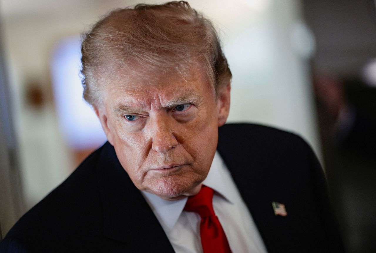 US President Donald Trump speaks to reporters aboard Air Force One en route to Michigan on July 27.